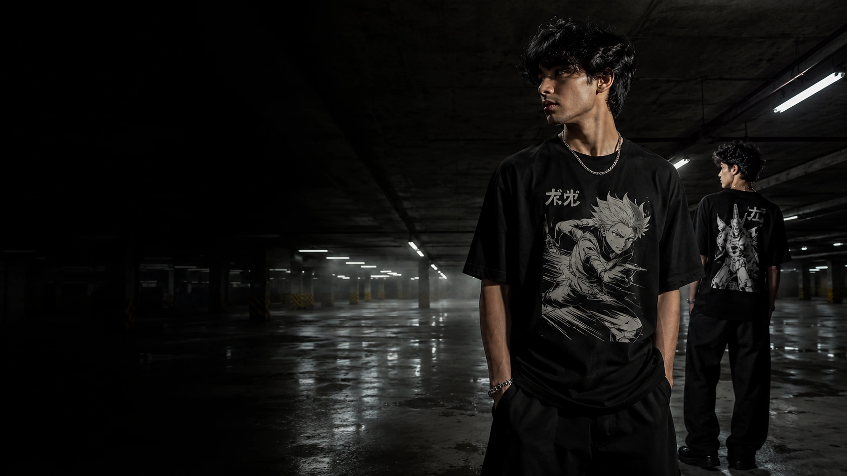 Two young men in black graphic T-shirts in a dimly lit parking garage